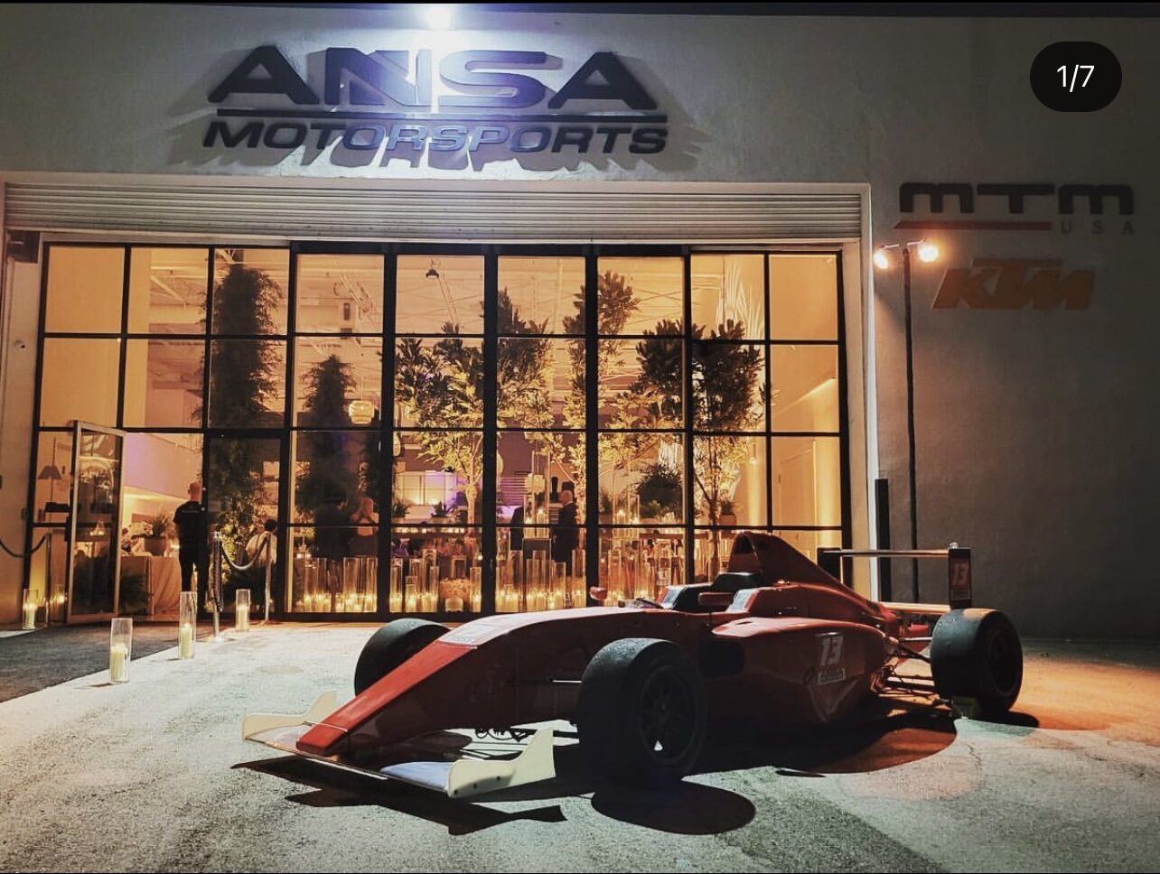 ANSA Motorsports entrance at night during a private event